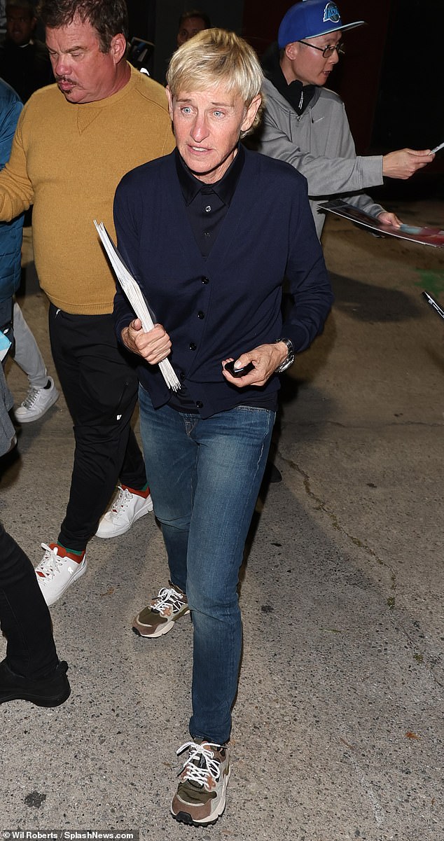 The former talk show host opted for a navy cardigan and jeans while sporting her signature short hair.