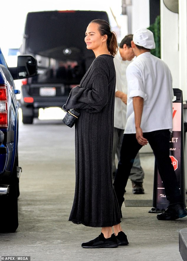 Teigen's dark hair was styled in a low ponytail and she appeared makeup-free.