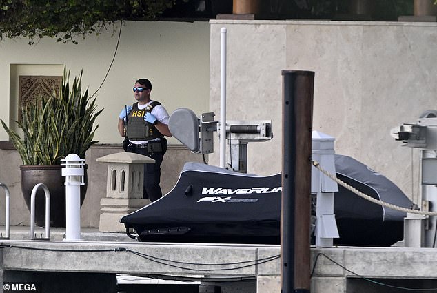 An HSI (Homeland Security Investigations) officer is seen at Diddy's oceanfront mansion in Miami on Monday.