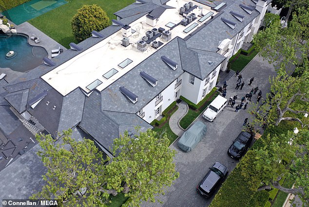 Homeland Security agents are seen outside Diddy's home in Los Angeles on Monday as part of an ongoing investigation into sex trafficking.