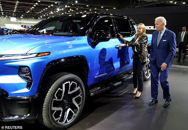 US President Joe Biden receives a Chevrolet Silverado EV from General Motors CEO Mary Barra during a visit to the Detroit Auto Show to highlight American electric vehicle manufacturing, in Detroit, Michigan, US. , on September 14, 2022.