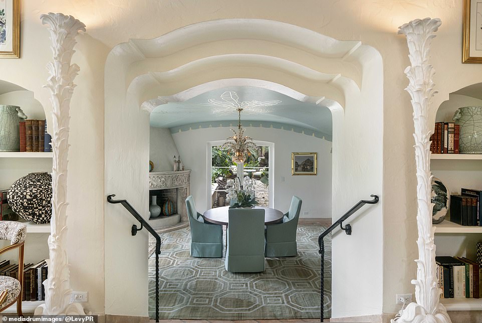 Highlights of the mansion include a dining room with a pastel blue vaulted ceiling, an oversized living room with colorful lighting and built-in bookshelves.