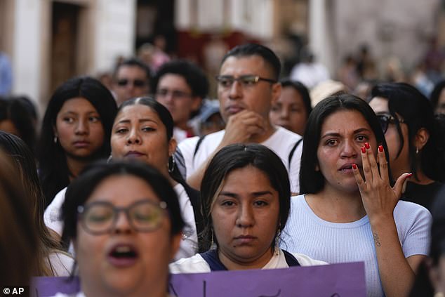 A woman wipes away tears during a demonstration protesting the kidnapping and murder of an 8-year-old girl, in the main square of Taxco, Mexico.