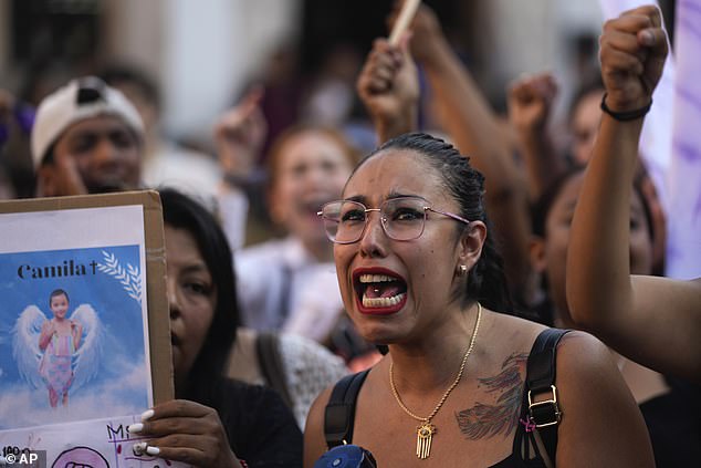 A woman sings the Spanish word for "justice" During a protest demonstration over the kidnapping and murder of an 8-year-old girl, in the main square of Taxco, Mexico, on Thursday.