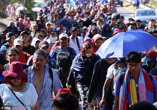 Migrants who make up the 'Viacrusis migrante' walk in a caravan in the municipality of Villa Comatitlán in the state of Chiapas, Mexico, on March 28=7.