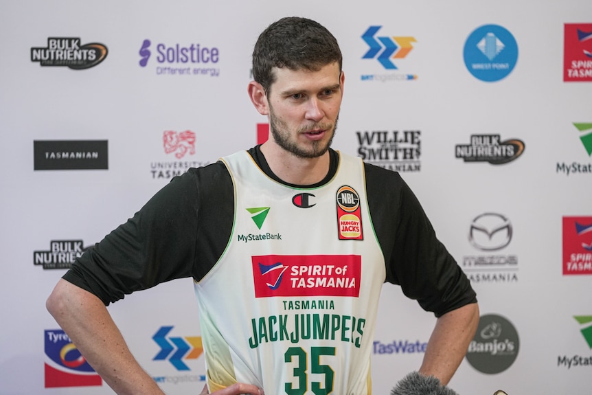 A basketball player talking to the media off camera.