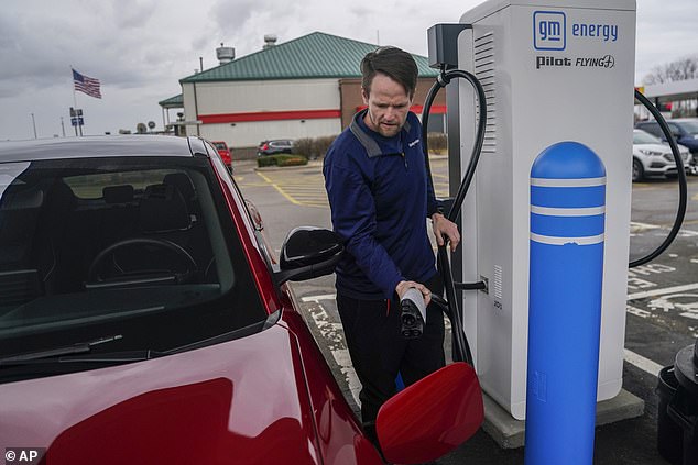 Liam Sawyer of Indianapolis charges his 2023 Ford Mustang Mach-E earlier this month at one of the operational charging stations built with money from infrastructure bills. This one is located in London, Ohio.