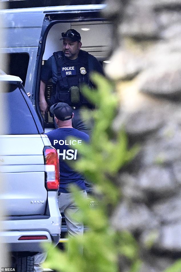 Police and Homeland Security agents are seen at Diddy's beachfront mansion in Miami on Monday.
