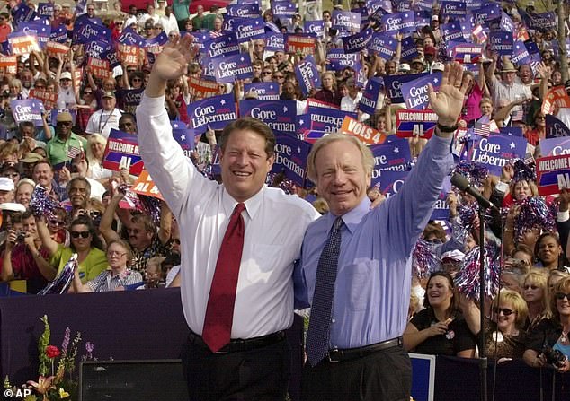 Democratic presidential candidate Vice President Al Gore (left) and his running mate, Senator Joe Lieberman of Connecticut, greet supporters at a campaign rally in Jackson, Tennessee, on October 25, 2000. Lieberman, who almost won the Democratic vice presidency alongside Gore in the disputed 2000 election and who almost became Republican John McCain's running mate eight years later, died on Wednesday, March 27.