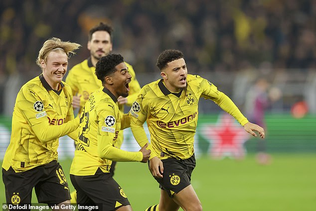 Jadon Sancho celebrates with his teammates after giving Borussia Dortmund an early lead against PSV Eindhoven in the Champions League on Wednesday night.