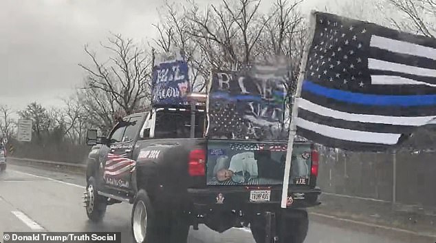 A representation of the current president tied up was on the back of a large truck with multiple flags supporting the police and a red license plate reading 'TRUMP4US', as well as a painting of the opening of the Constitution.