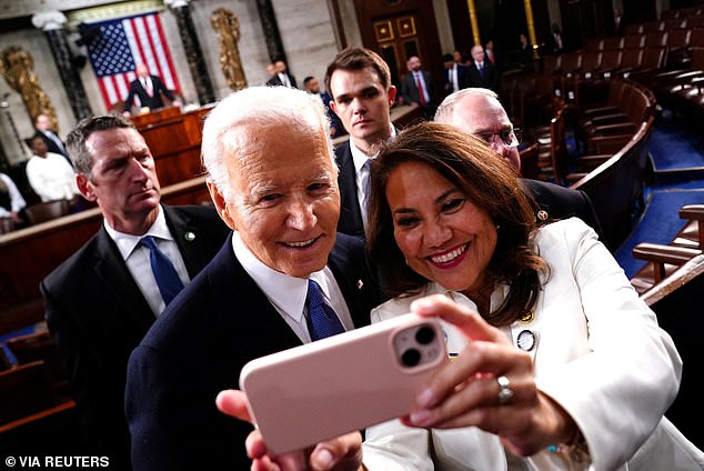 President Joe Biden takes a selfie with Rep. Veronica Escobar, a member of the Congressional Hispanic Caucus, after delivering his State of the Union and mentioning the term 'illegal'