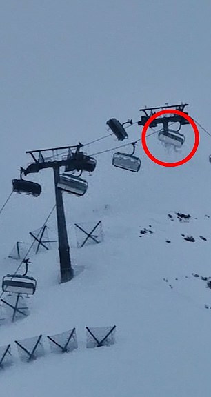 Mrs. Burt and Mr. Dunning's skis can be seen hanging from the chairlift as they are pushed by the wind.