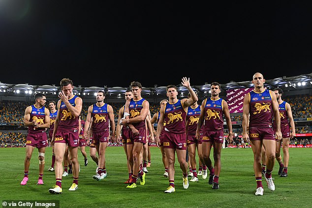 Lions players pictured leaving the field after their loss to Collingwood