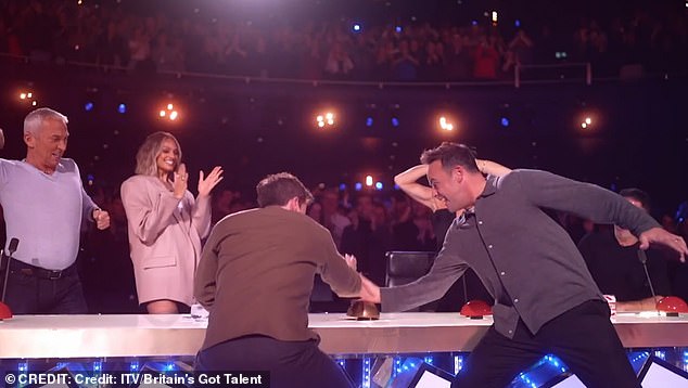 The judges can be seen celebrating and applauding as each presses their Golden Buzzer while the audience can be seen standing up and shouting behind them.