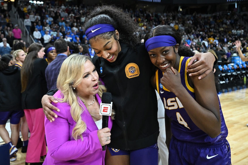 LSU basketball player Angel Reese hugs ESPN interviewer and teammate Flau'jae Johnson.
