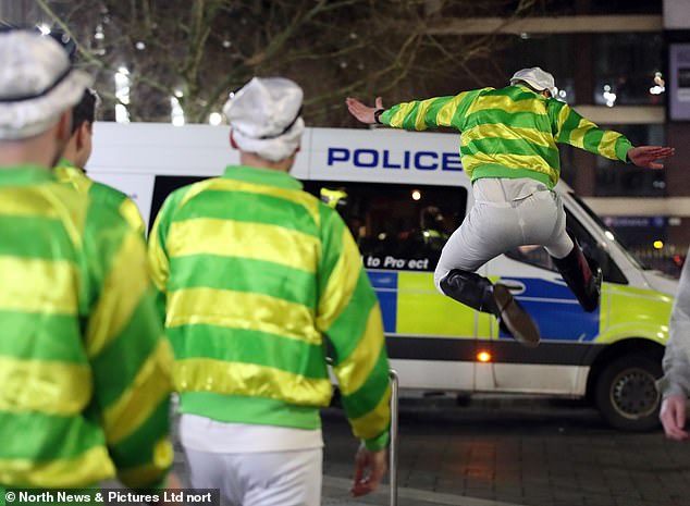 A jockey jumps for joy as he jumps towards a police van in Newcastle city centre.