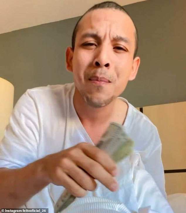 Leonel Moreno, 27, sings lyrics in Spanish and waves a wad of $100 bills at the camera.