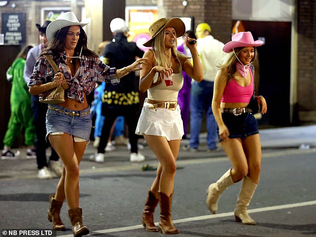 Three women dressed in jeans celebrate the four day weekend as they head out to Leeds