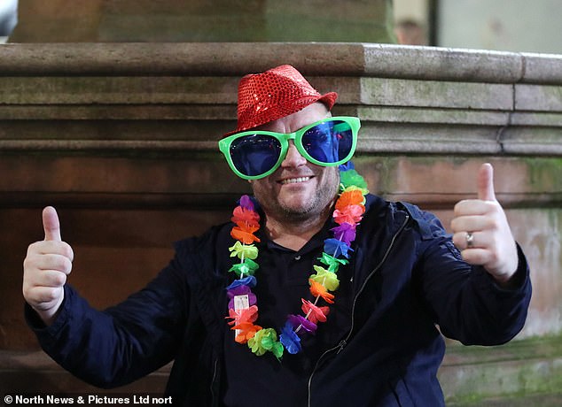 Applause for Easter!  A reveler wore a bright red hat, a flower garland and novelty glasses during their night out.