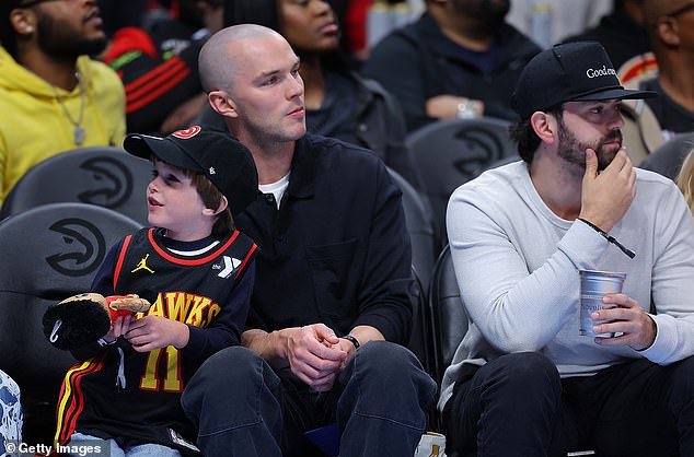 The Skins actor, 34, has been tapped to play Warner Bros.' highly anticipated iconic villain Superman: Legacy (pictured with his son in Atlanta)