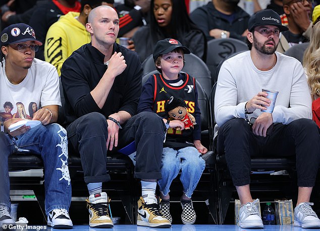 Nicholas completed his look with a pair of white ankle-high socks and yellow and white Nike sneakers.
