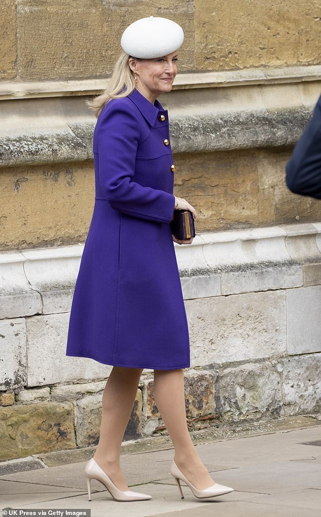 The mother-of-two paired the stylish jacket with an amethyst crocodile-print clutch and a chic white beret, which she placed on the side of her head.