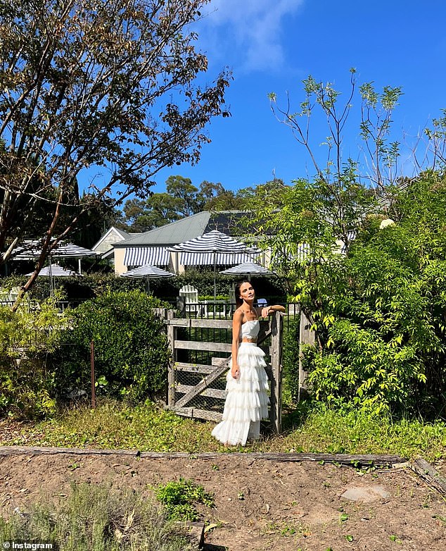 The former Neighbors star strolled flirtatiously through an immaculately green garden in a series of images shared on Instagram.