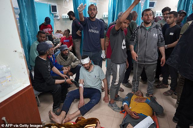Injured Palestinian men lie on the floor of the Al-Aqsa Martyrs Hospital in Deir al-Balah, central Gaza Strip, following the Israeli bombardment on March 31.