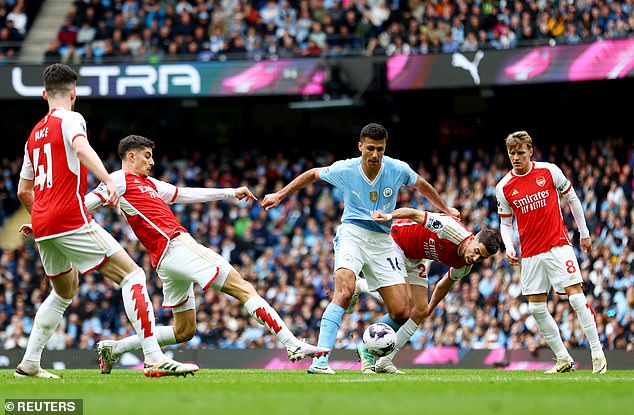 Rodri (centre) was ever-present at the base of City's midfield as they attempted to break down the Gunners' defence.