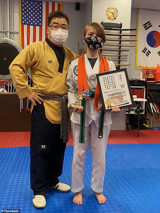 Gregg (right) receiving a martial arts award