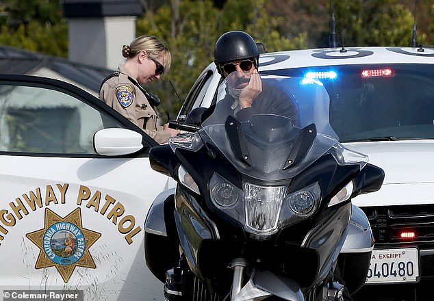 Kiedis was seen on his BMW cruiser motorcycle with his hand under his chin as he waited for the officer to write the ticket.