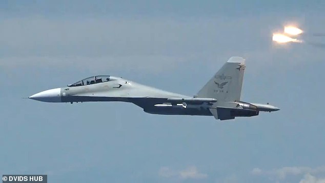 Thirty-two Chinese warplanes were detected over Taiwan in just 24 hours, the country's Defense Ministry said.  Pictured: File photo of a Chinese plane near an American fighter
