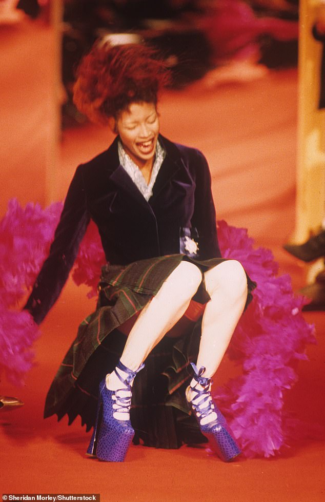 The supermodel fell while wearing the blue platform-heeled Super Elevated Gillie shoes, handmade from fake crocodile leather with nine-inch heels (pictured in Paris in 1993)
