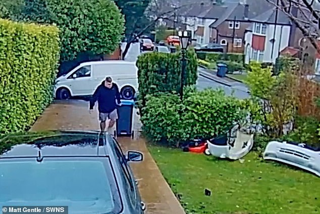 Matt Gentle, 40, from Croydon, pulling a wheelie bin at the end of his driveway