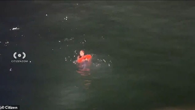 The woman was seen paddling in the water, while a Los Angeles Sheriff's Department boat attempted to save her by throwing a flotation donut into the ocean which she clung to and was then hoisted onto the boat.