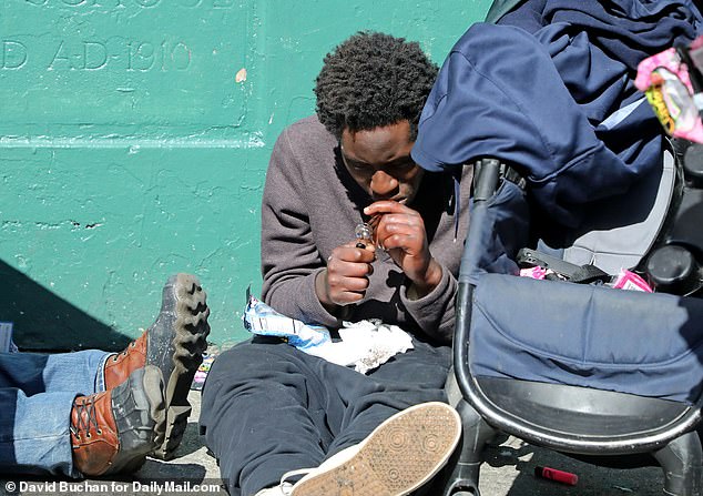 In the photo above, a man is seen taking drugs on the street in San Francisco