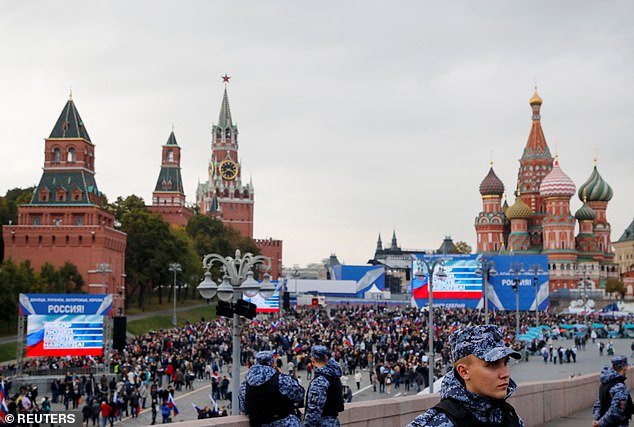 Law enforcement officers stand guard as people walk to Red Square to attend events marking the annexation of Ukraine's Russian-controlled territories, September 30, 2022.