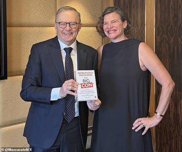 Anthony Albanese poses with Big Con book by economist Mariana