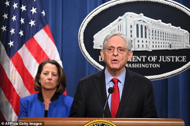U.S. Attorney General Merrick Garland, accompanied by Deputy Attorney General Lisa Monaco (left), announces an antitrust lawsuit against Apple, at the Department of Justice in Washington, DC, March 21.