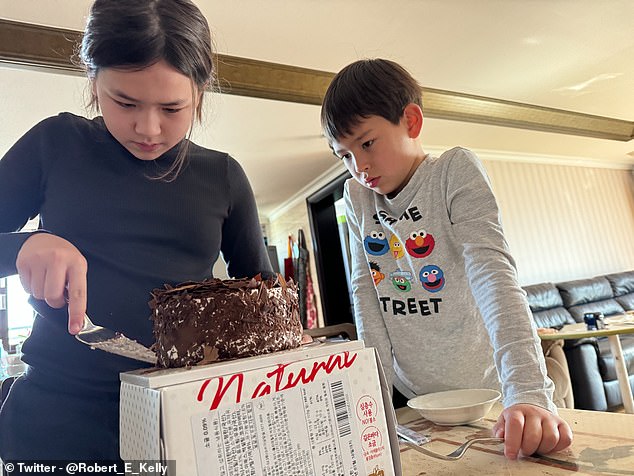 Robert E Kelly has shared photos of his adorable children seven years after they shot to fame by crashing his BBC interview.  Pictured: Marion cuts a cake for her 11th birthday while James watches