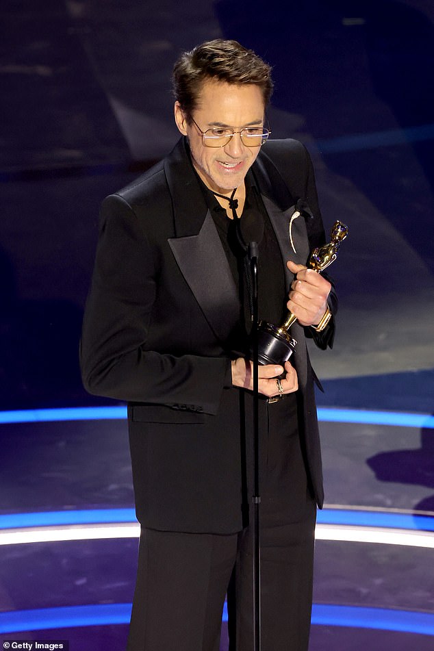 Robert Downey Jr.  seen with an Oscar for Best Supporting Actor
