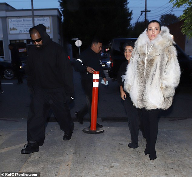 Bianca Censori, 29, ditched her recent bold look and sported a thick coat as she stepped out to dinner with her stepdaughter, North West, 10, and husband Kanye West, 46, on Saturday.