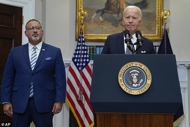 Education Secretary Miguel Cardona stands with President Biden at the White House after the Supreme Court blocked the president's original $400 billion plan to cancel student loan debt.