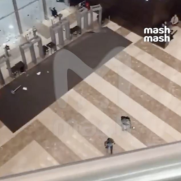 A clip shows a terrorist running through the concert hall's security doors.