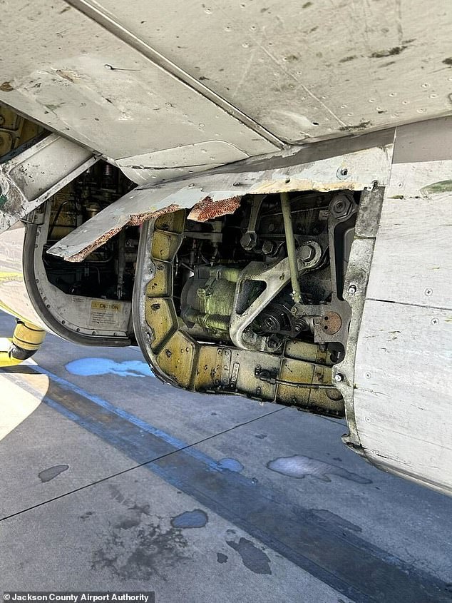 A United Airlines plane built by Boeing was grounded Friday after it was found to be missing a panel after it landed after a flight.  Pictured: The missing part on the 25-year-old Boeing 737-824
