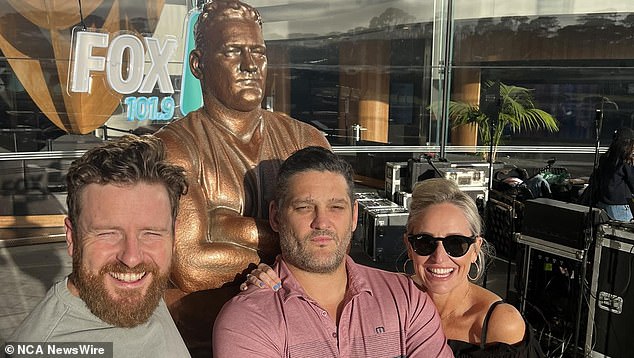 Fevola (centre, with his radio co-stars Fifi Box, right, and Nick Cody, left) is pictured with a statue unveiled in his honor in Narre Warren, the Melbourne suburb where he grew up.