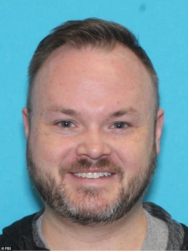 Adam Stafford King, seen in a photo of his driver's license, has been charged with knowingly distributing child pornography following an investigation led by the FBI.