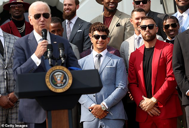 Butker can be seen over Biden's left shoulder wearing a pro-life tie with his gray suit jacket