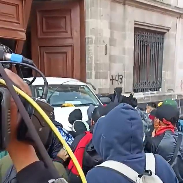 Protesters were captured on video pushing a van before breaking through the gate of the National Palace in Mexico City on Wednesday.